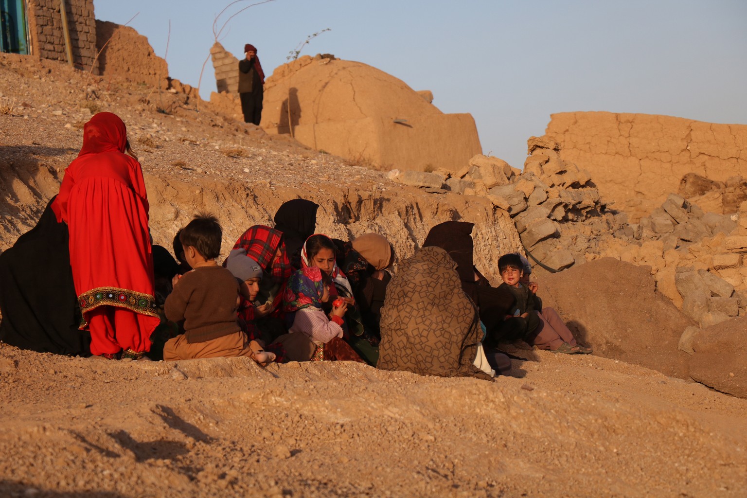 epa10906242 People hit by an earthquake wait for help in Herat, Afghanistan, October 7, 2023. At least 15 people have lost their lives and sustained injuries after a series of seven ...