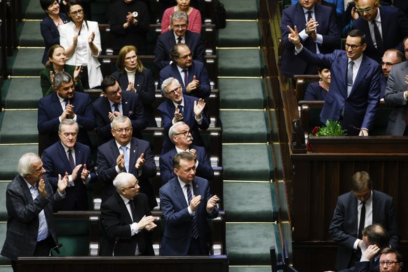 Poland&#039;s Prime Minister Mateusz Morawiecki, right, waves after losing confidence vote at the parliament, in Warsaw, Poland, Monday Dec. 11, 2023. Polish Prime Minister Mateusz Morawiecki&#039;s g ...