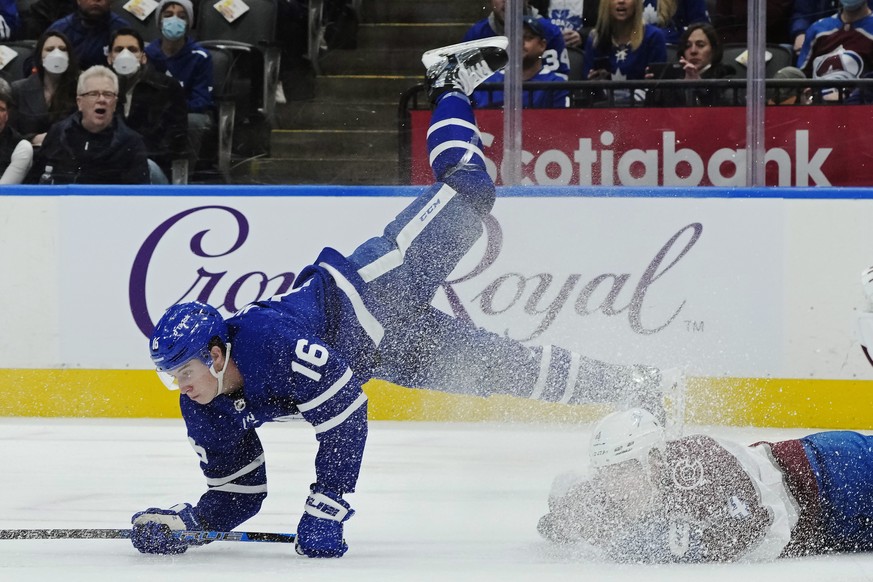 Toronto Maple Leafs forward Mitchell Marner (16) is tripped up by Colorado Avalanche defenseman Bowen Byram (4) during the second period of an NHL hockey game Wednesday, Dec 1, 2021, in Toronto. (Nath ...