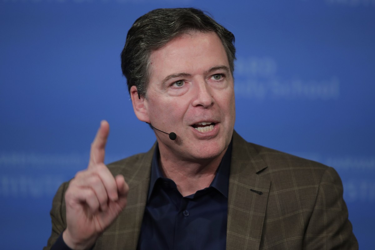 FILE - Former Director of the Federal Bureau of Investigation James Comey speaks at Harvard University's Institute of Politics' JFK Jr. Forum in Cambridge, Mass., Feb. 24, 2020. (AP Photo/Ch ...