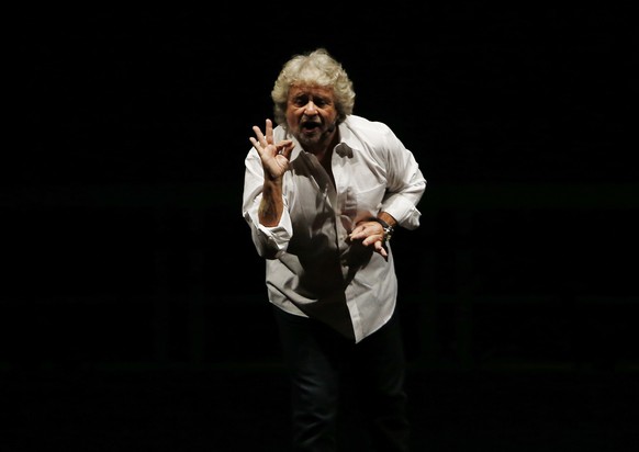 FILE - In this Tuesday Feb. 2, 2016 file photo, Beppe Grillo, leader of the anti-establishment 5-Stars Movement, performs in Milan, Italy. The day the anti-establishment 5-Star Movement triumphed in R ...