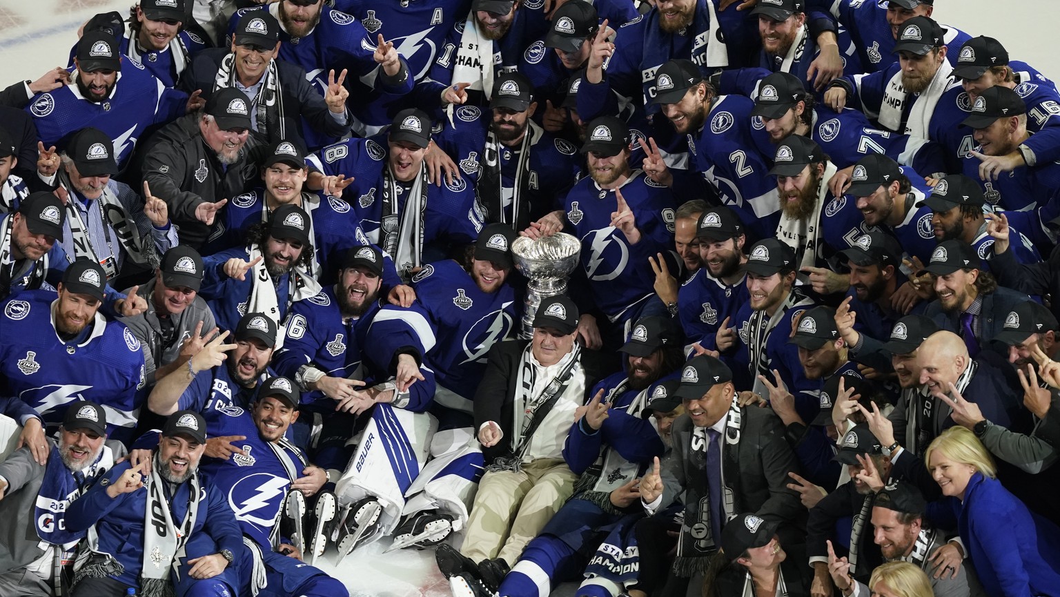 The Tampa Bay Lightning team poses with the Stanley Cup after Game 5 of the NHL hockey Stanley Cup finals against the Montreal Canadiens, Wednesday, July 7, 2021, in Tampa, Fla. (AP Photo/Gerry Broome ...