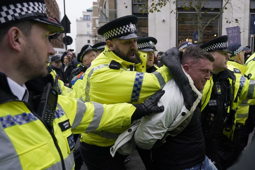 Far-right activist Stephen Yaxley-Lennon known as Tommy Robinson is arrested by polices during an anti-Semitism demonstration in London, Sunday, Nov. 26, 2023. (AP Photo/Alberto Pezzali)