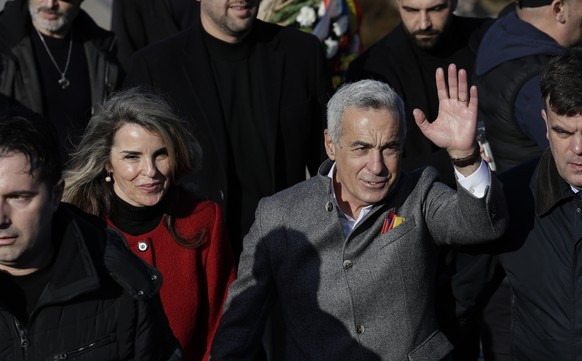 epa11850164 Calin Georgescu (R), the independent candidate who won the first round of Romania&#039;s annulled presidential elections, and his wife Cristela (L) attend a &#039;Little Union Day&#039; ce ...
