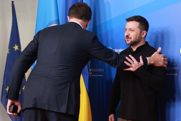 epa11403411 Dutch Prime Minister Mark Rutte (L) greets Ukrainian President Volodymyr Zelensky (R) upon his arrival for the Ukraine Recovery Conference 2024 in Berlin, Germany, 11 June 2024. The Ukrain ...