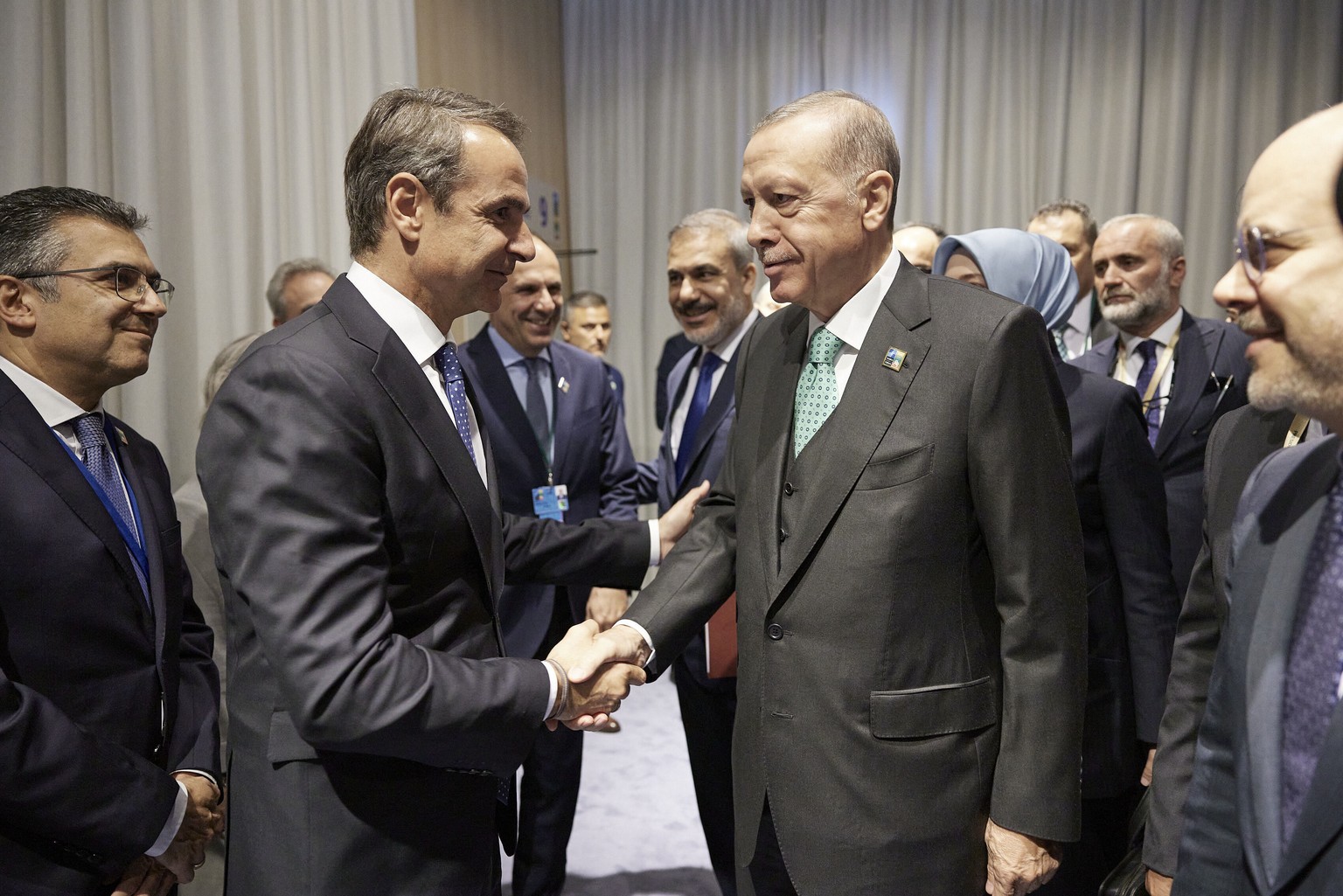 In this photo provided by the Greek Prime Minister&#039;s Office, Greece&#039;s Prime Minister Kyriakos Mitsotakis, left, shakes hands with Turkey&#039;s President Recep Tayyip Erdogan prior to their  ...
