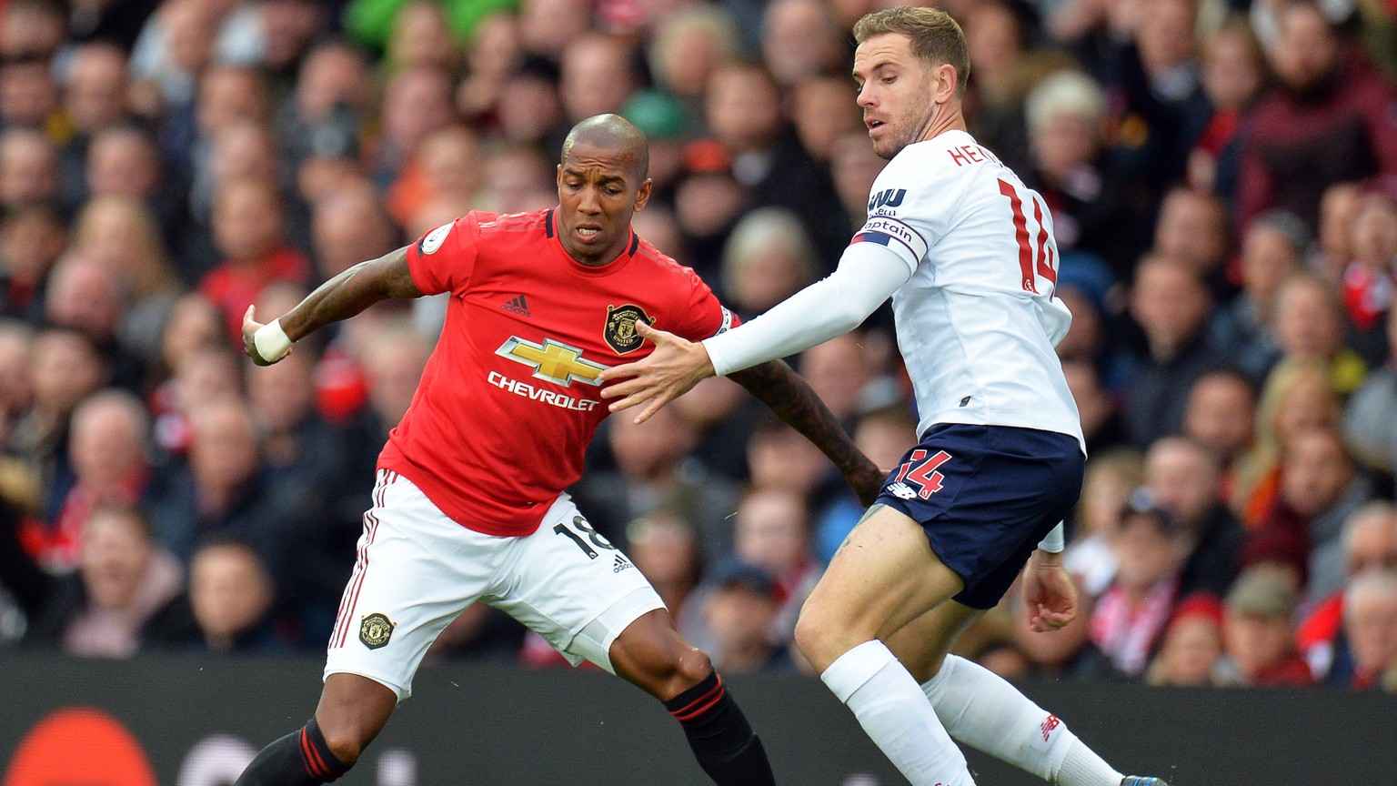 epa07936932 Liverpool&#039;s Jordan Henderson (R) in action against Manchester United&#039;s Ashley Young (L) during the English Premier League soccer match between Manchester United and Liverpool FC  ...