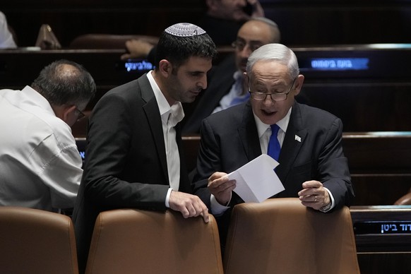Israeli Prime Minister Benjamin Netanyahu, right, speaks with Communications Minister Shlomo Karhi at the Knesset, Israel's parliament, in Jerusalem, Monday, July 10, 2023. (AP Photo/Maya A ...