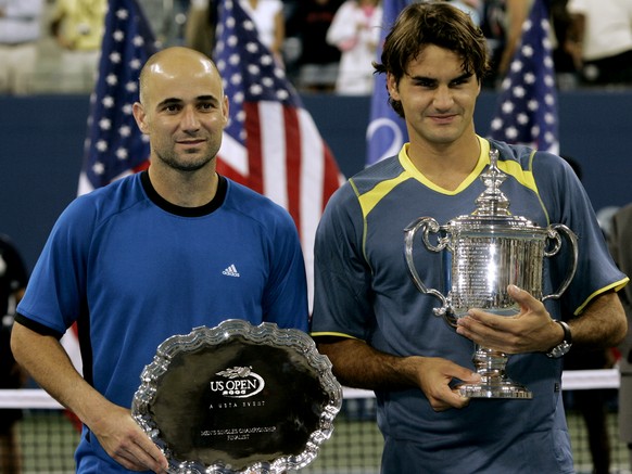 Roger Federer of Switzerland, right, and Andre Agassi of the United States, pose with their trophies after the mens final at the US Open tennis tournament in New York, Sunday, Sept. 11, 2005. Federer  ...