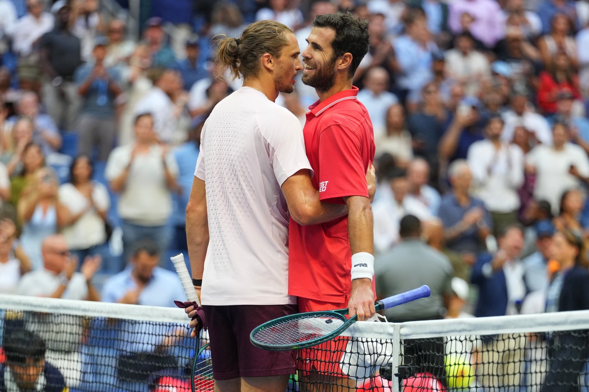 Alexander Zverev, of Germany, left, and Karen Khachanov, of Russia, right, meet at the net after Zverev won their match during the men's singles semifinals of the U.S. Open tennis championships,  ...