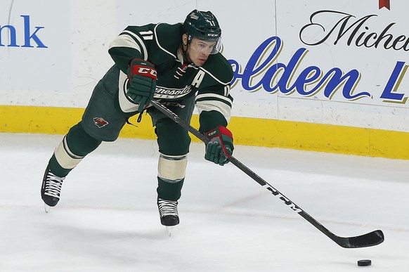 This Nov. 25, 2016 photo shows Minnesota Wild&#039;s Zach Parise controlling the puck against the Pittsburgh Penguins in the first period of an NHL hockey game in St. Paul, Minn. Minnesota Wild forwar ...