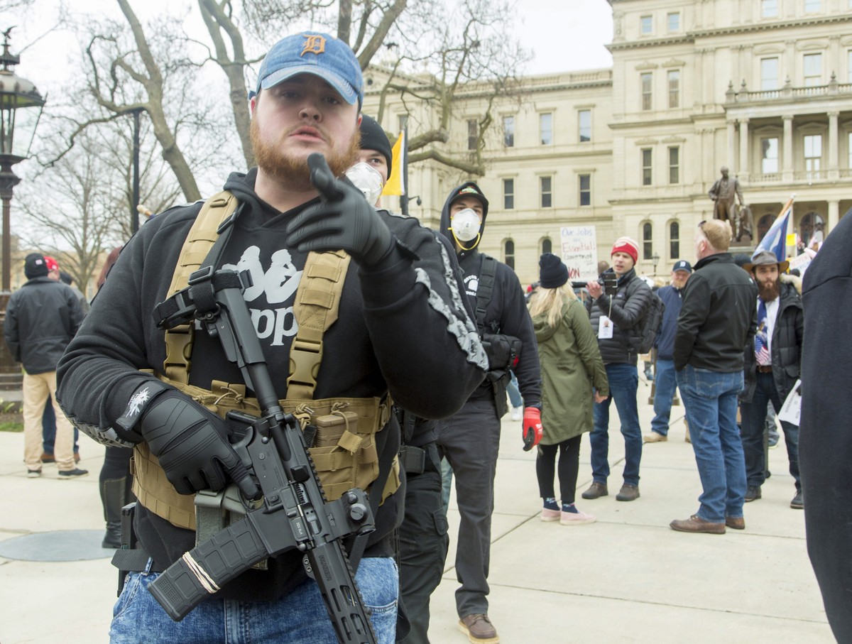 epa08364992 Protesters open carrying their firearms join in 'Operation Gridlock' in front of the Michigan state Capitol in Lansing, Michigan, USA, 15 April 2020. The protest organizers, The  ...