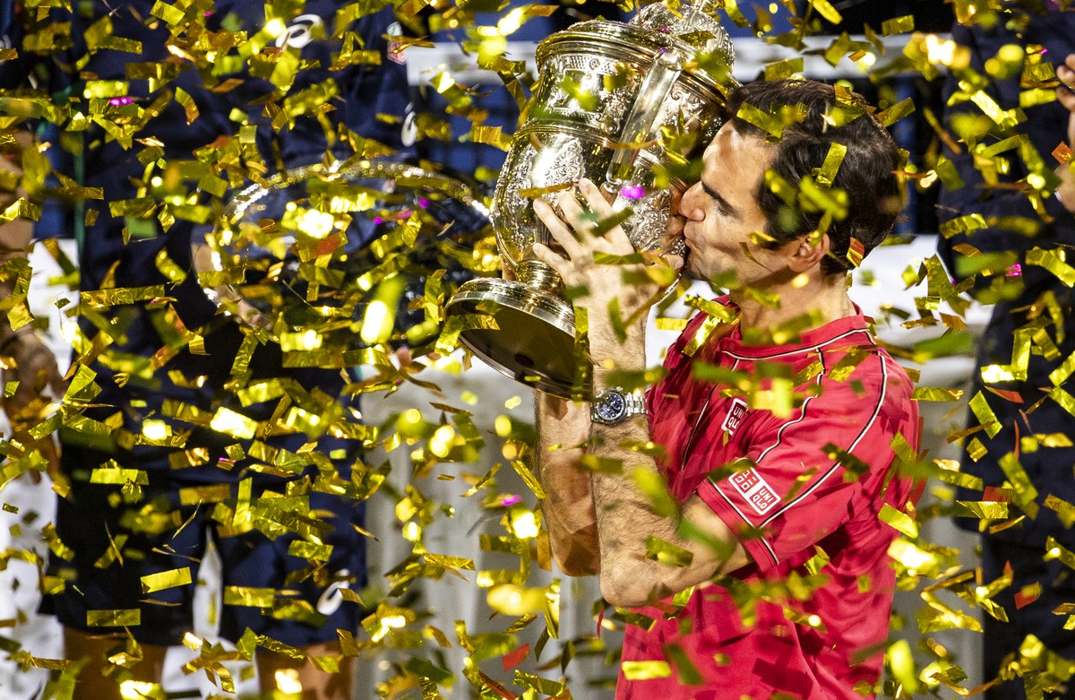 Roger Federer of Switzerland poses with his trophy after defeating Alex De Minaur of Australia after the final match at the Swiss Indoors tennis tournament at the St. Jakobshalle in Basel, Switzerland ...