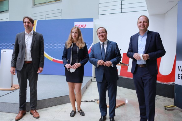 epa09436696 Armin Laschet (2-R), top candidate of the Christian Democratic Union of Germany (CDU) political party and Prime Minister of North Rhine-Westphalia, next to CDU politicians Andreas Jung (L) ...