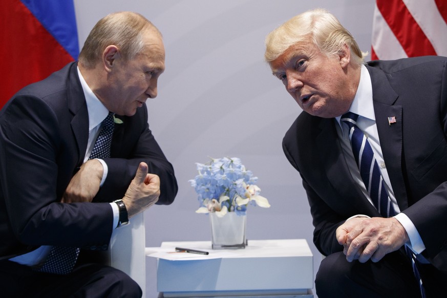 FILE - In this file photo taken on Friday, July 7, 2017, U.S. President Donald Trump meets with Russian President Vladimir Putin at the G-20 Summit in Hamburg, Germany. Vladimir Putin looks more invin ...