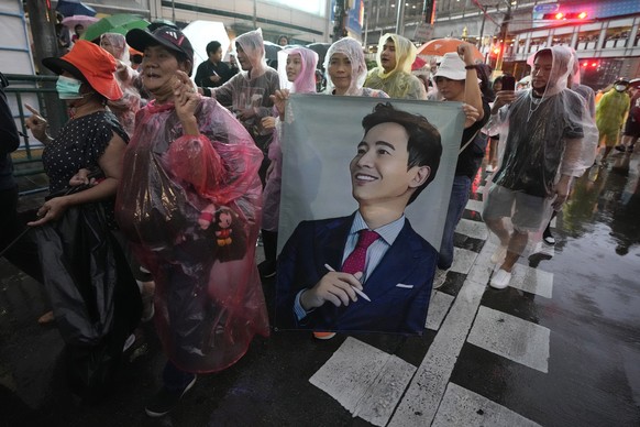 Supporters of the Move Forward Party hold a portrait of Pita Limjaroenrat, the leader of Move Forward Party, during a protest in Bangkok, Thailand, Sunday, July 23, 2023. The demonstrators are protest ...