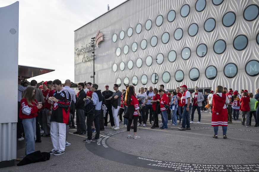 Fans stand in line in front of a food stand to cater themselves outside the stadium, ahead of the 2026 IIHF Men's Ice Hockey World Championship preliminary round group A game between Switzerland  ...