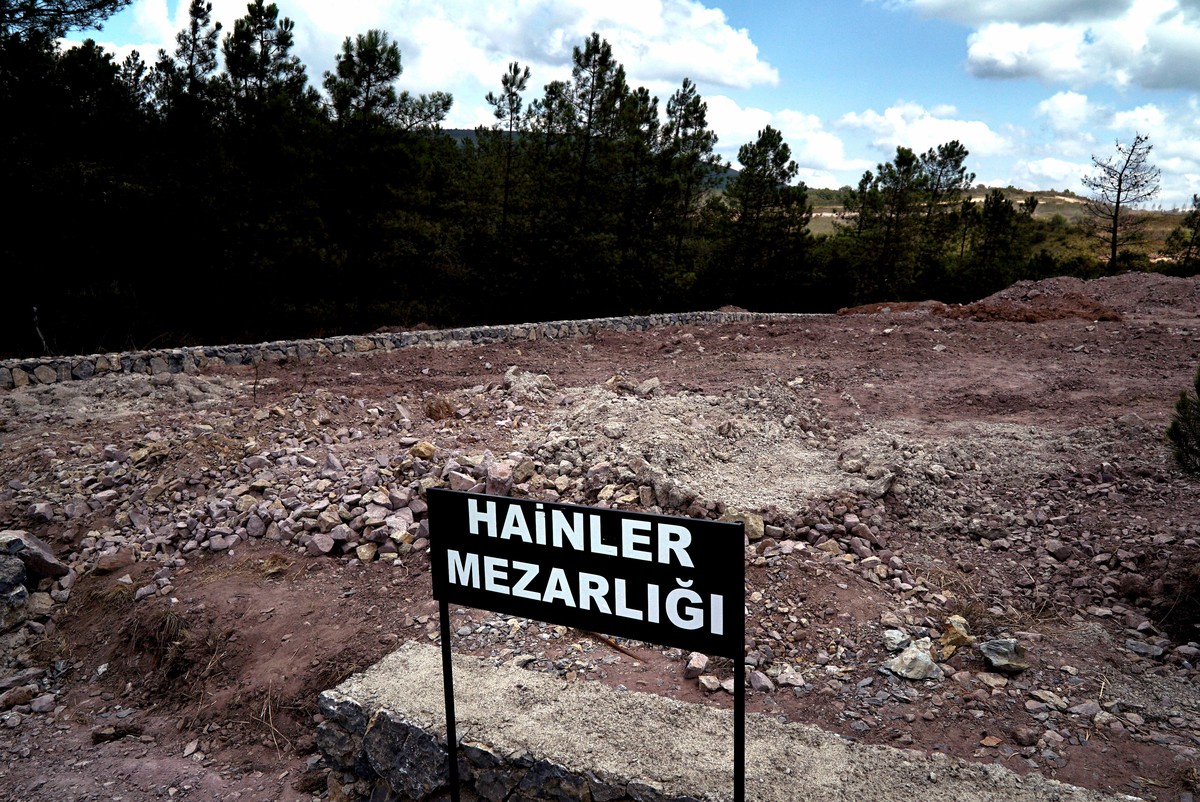 CORRECTS PHOTOGRAPHER'S NAME - A sign reading in Turkish "Traitors' Cemetery" is seen in front of unmarked graves, built specifically to hold the bodies of coup plotters who died i ...