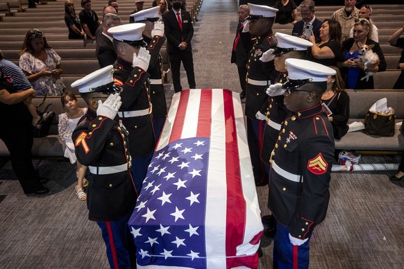 epa09475742 Marines salute the coffin of late U.S. Marine Kareem Grant Nikoui before carrying it outside following a memorial ceremony at Harvest Christian Fellowship in Riverside, USA, 18 September 2 ...