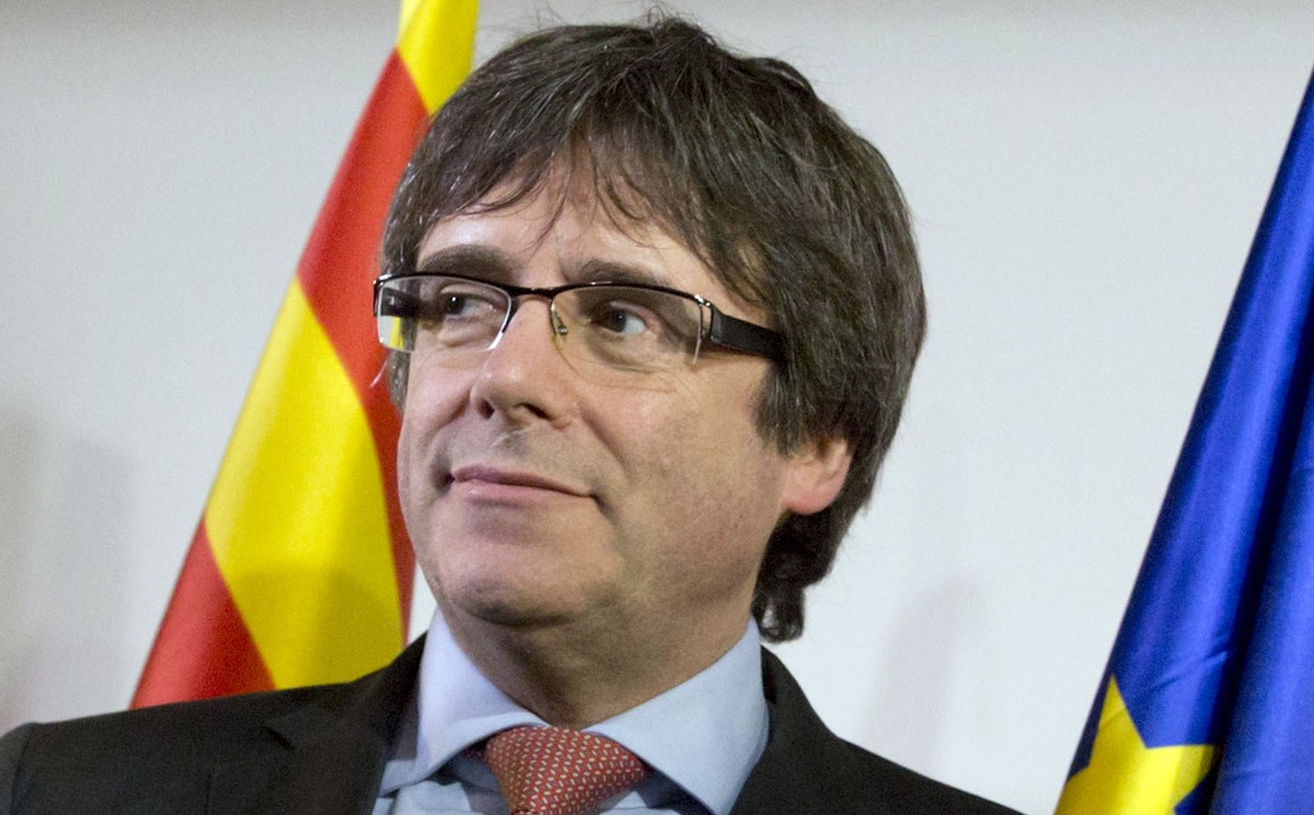 FILE - In this Dec. 21, 2017 file photo ousted Catalan leader Carles Puigdemont takes the podium at a gathering to watch the election results for Spain's Catalonia region at the Square Meeting Ce ...