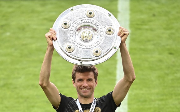 Bayern&#039;s Thomas Mueller holds a trophy of the best scorer of the season after winning the Bundesliga title after the German Bundesliga soccer match between Bayern Munich and FC Augsburg at the Al ...