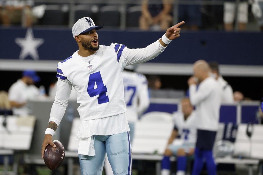 Dallas Cowboys' Dak Prescott gestures as he stands on the field during warmups before a preseason NFL football game against the Houston Texans in Arlington, Texas, Saturday, Aug. 21, 2021. (AP Photo/M ...