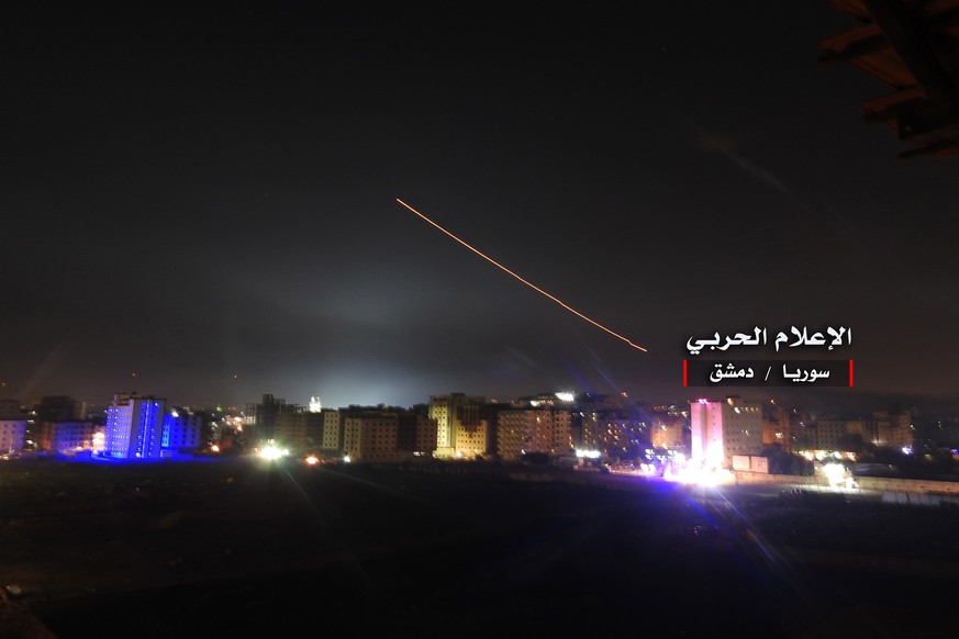 epa06724728 A handout photo made available by government-affiliated Syrian Military Media is said to show Syrian air defense missiles intercepting missile strikes over Damascus, Syria, 09 May 2018 (is ...