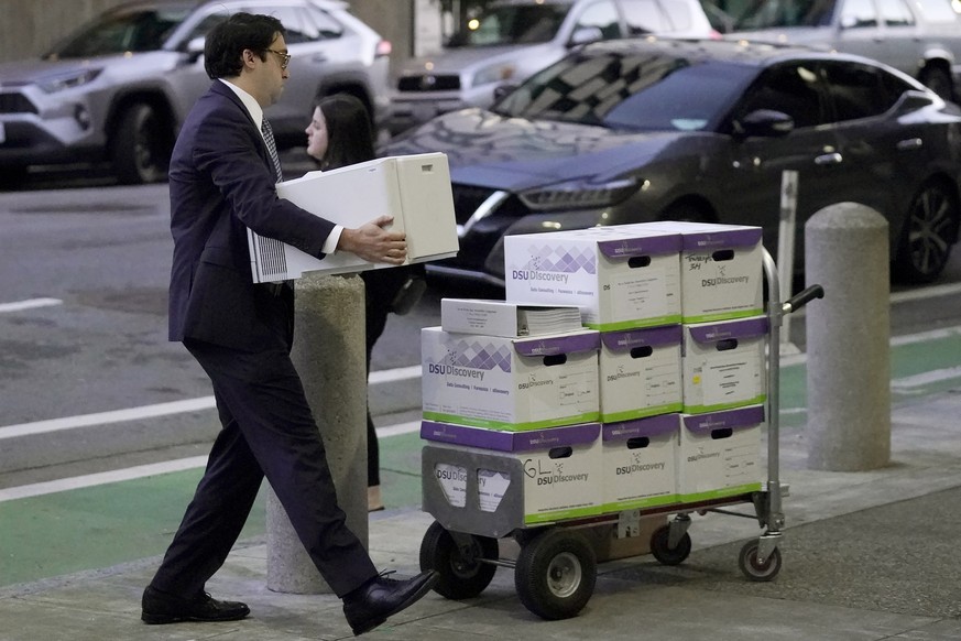 Documents related to the class-action lawsuit on behalf of investors who owned Tesla stock in August 2018 are loaded onto a cart outside of a federal courthouse in San Francisco, Tuesday, Jan. 17, 202 ...