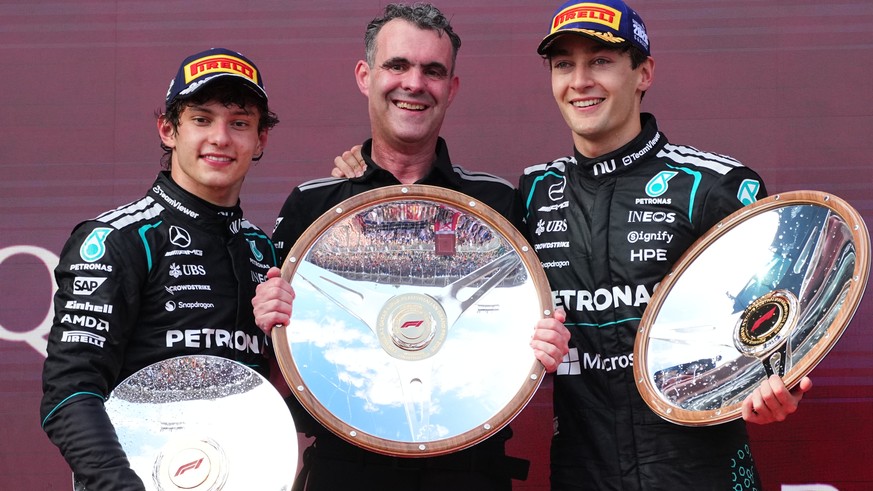 Mercedes driver George Russell of Britain, right, celebrates with second placed teammate Andrea Kimi Antonelli, left, of Italy and Hywel Thomas, Managing director of Mercedes AMG High Performance Powe ...