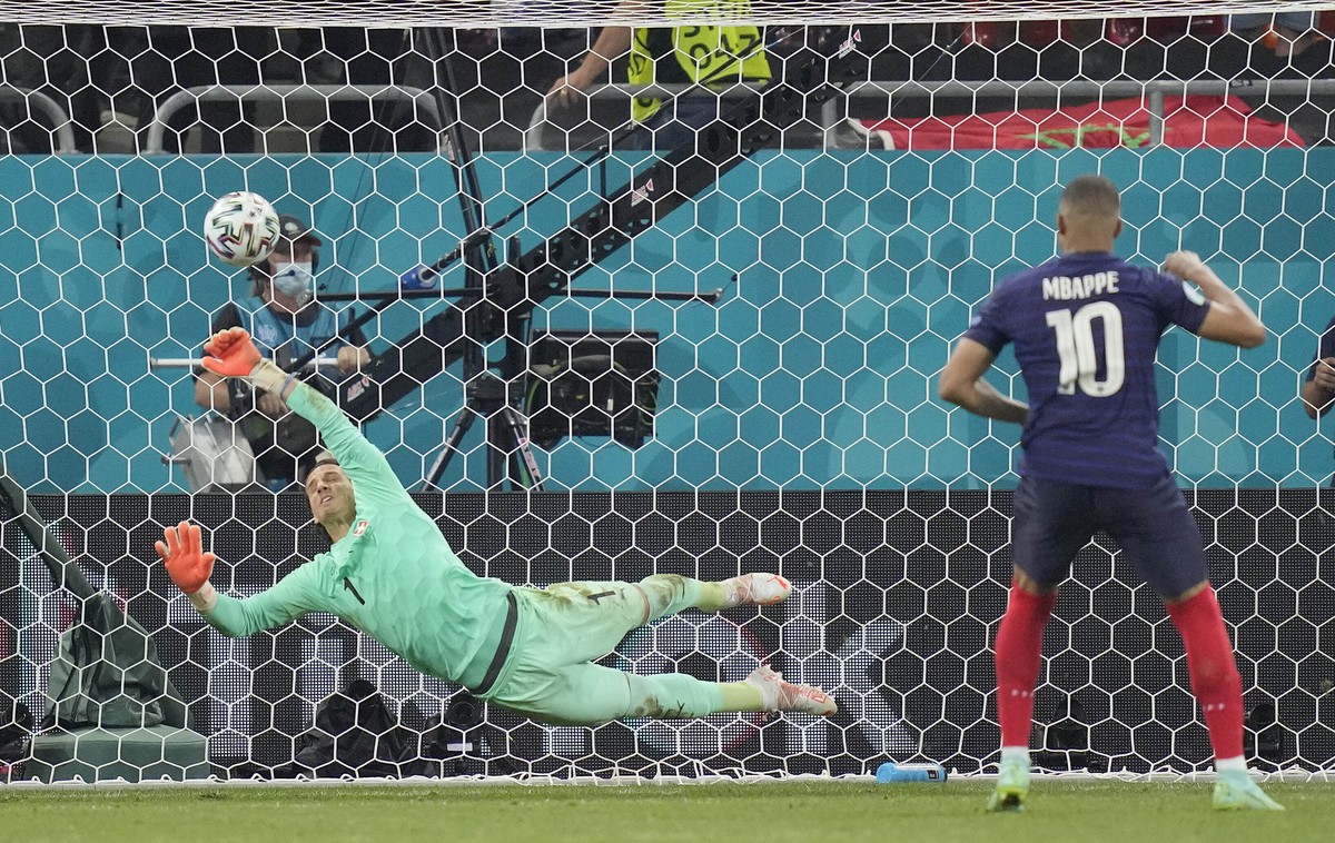 Switzerland's goalkeeper Yann Sommer saves the penalty shot by France's Kylian Mbappe during the Euro 2020 soccer championship round of 16 match between France and Switzerland at the Nationa ...