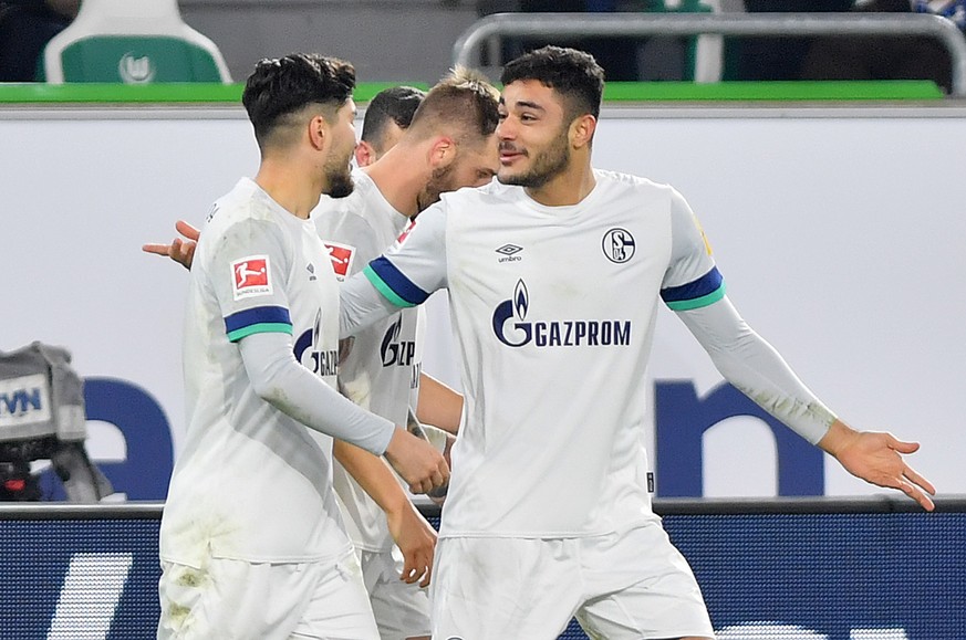 epa08080336 Ozan Kabak of Schalke (C) reacts after scoring during the German Bundesliga soccer match between VfL Wolfsburg and FC Schalke 04 in Wolfsburg,Â Germany, 18 December 2019. EPA/DAVID HECKER  ...