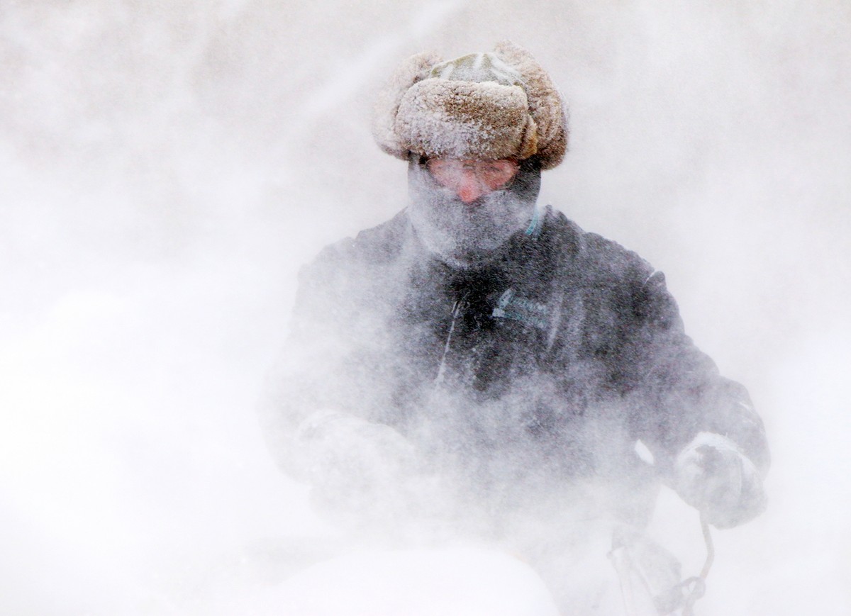 Garret Kelenske, 49, works to remove snow on the sidewalk along Hoyt Street near Sacred Heart Church in Muskegon Heights, Mich., Tuesday, Jan. 7, 2014. He is the facility maintenance manager for the c ...