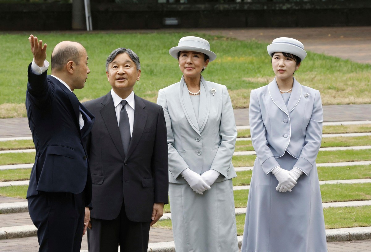 Japanese Emperor Naruhito, center left, Empress Masako center right, and Princess Aiko, right, listen to Nagasaki Mayor Shiro Suzuki, left, as they visit the cenotaph for the atomic bombing victims at ...