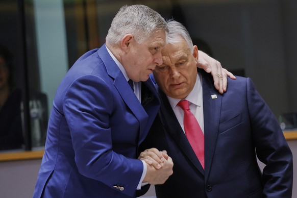 Slovakia&#039;s Prime Minister Robert Fico, left, speaks with Hungary&#039;s Prime Minister Viktor Orban during a round table meeting at an EU summit in Brussels, Thursday, March 20, 2025. (AP Photo/O ...