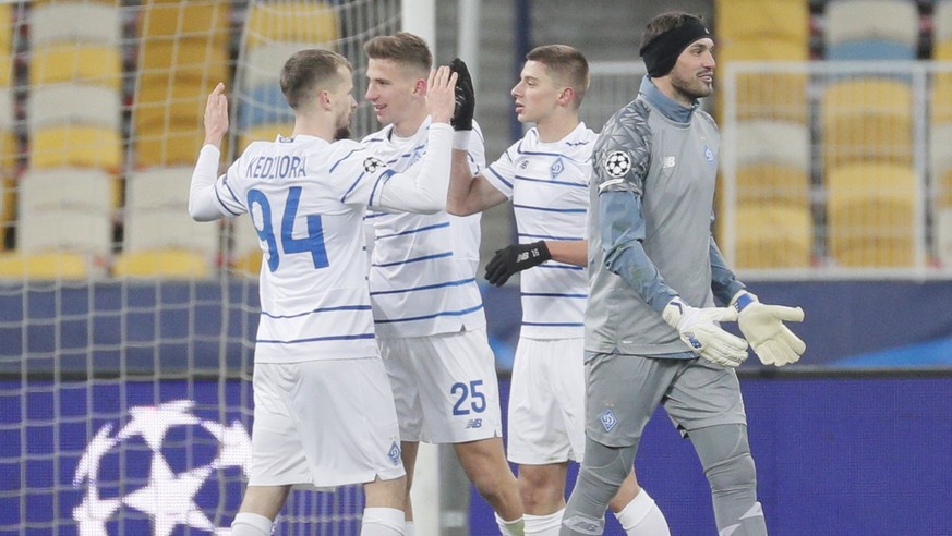 epa08871600 Tomasz Kedziora (L), Illya Zabarnyi (2L) of Kiev react after the UEFA Champions League group G soccer match between Dynamo Kiev and Ferencvaros Budapest in Kiev, Ukraine, 08 December 2020. ...