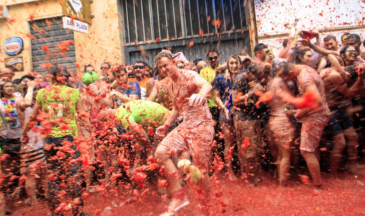 Revelers enjoy as they throw tomatoes at each other, during the annual "Tomatina", tomato fight fiesta, in the village of Bunol, 50 kilometers outside Valencia, Spain, Wednesday, Aug. 30, 20 ...