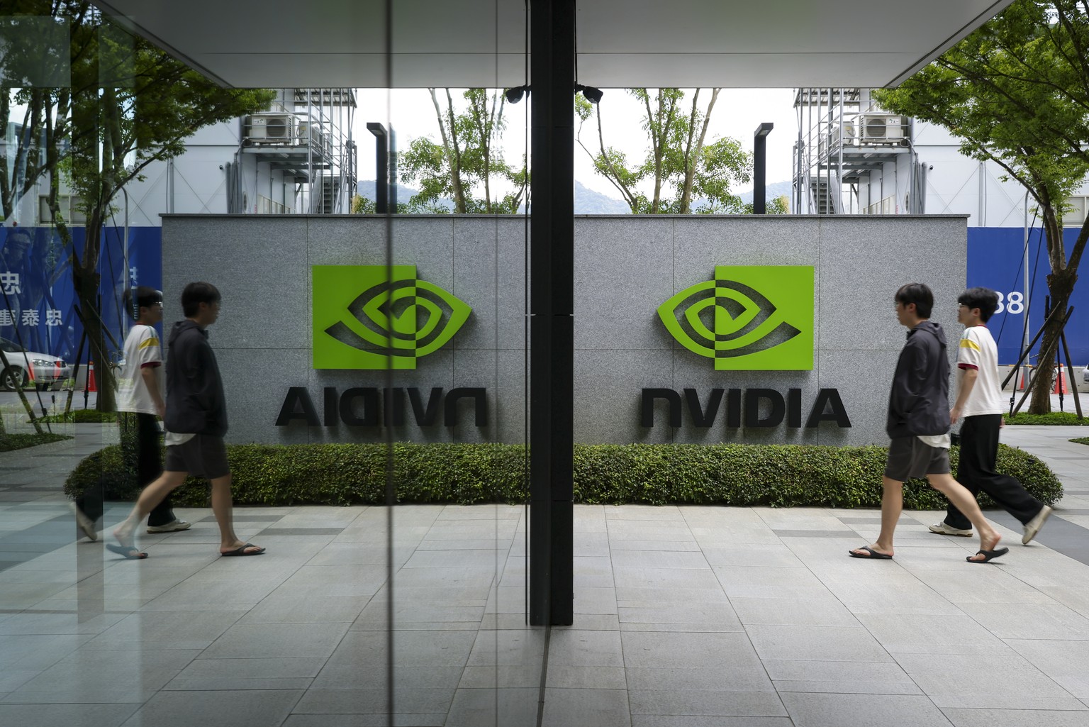 epaselect epa12976516 People walk past an NVIDIA logo sign displayed outside the corporation's headquarters in Taipei, Taiwan, 20 May 2026. NVIDIA is scheduled to report its Q1 Fiscal Year 2027 e ...