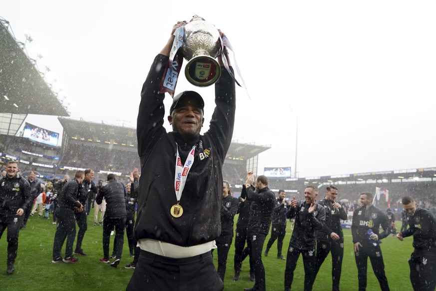 Burnley manager Vincent Kompany lifts the trophy after the English Football League Championship soccer match against Cardiff City at Turf Moor, Burnley, England, Monday, May 8, 2023. (Martin Rickett/P ...