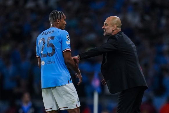 Manchester City&#039;s head coach Pep Guardiola, right, talks to Manchester City&#039;s Manuel Akanji during the Champions League final soccer match between Manchester City and Inter Milan at the Atat ...