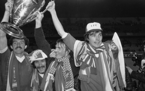 Liverpool players are jubilant as they show the trophy to their fans at the end of the European Soccer Cup final after they had defeated Real Madrid 1-0, at the Parc Des Princes Stadium, Paris, on May ...