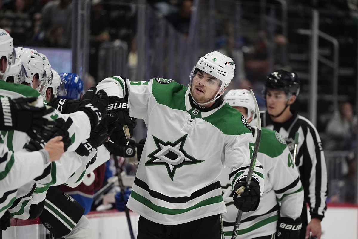 Dallas Stars defenseman Lian Bichsel is congratulated as he passes the team box after he scored the winning goal as time ran out in an NHL preseason hockey game against the Colorado Avalanche, Monday, ...
