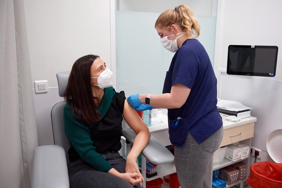 epa08913198 Vaccination against COVID-19 is administered to medical and administrative staff with the Pfizer-BioNTech COVID-19 vaccine at the University Clinical Center in Gdansk, Poland, 31 December  ...
