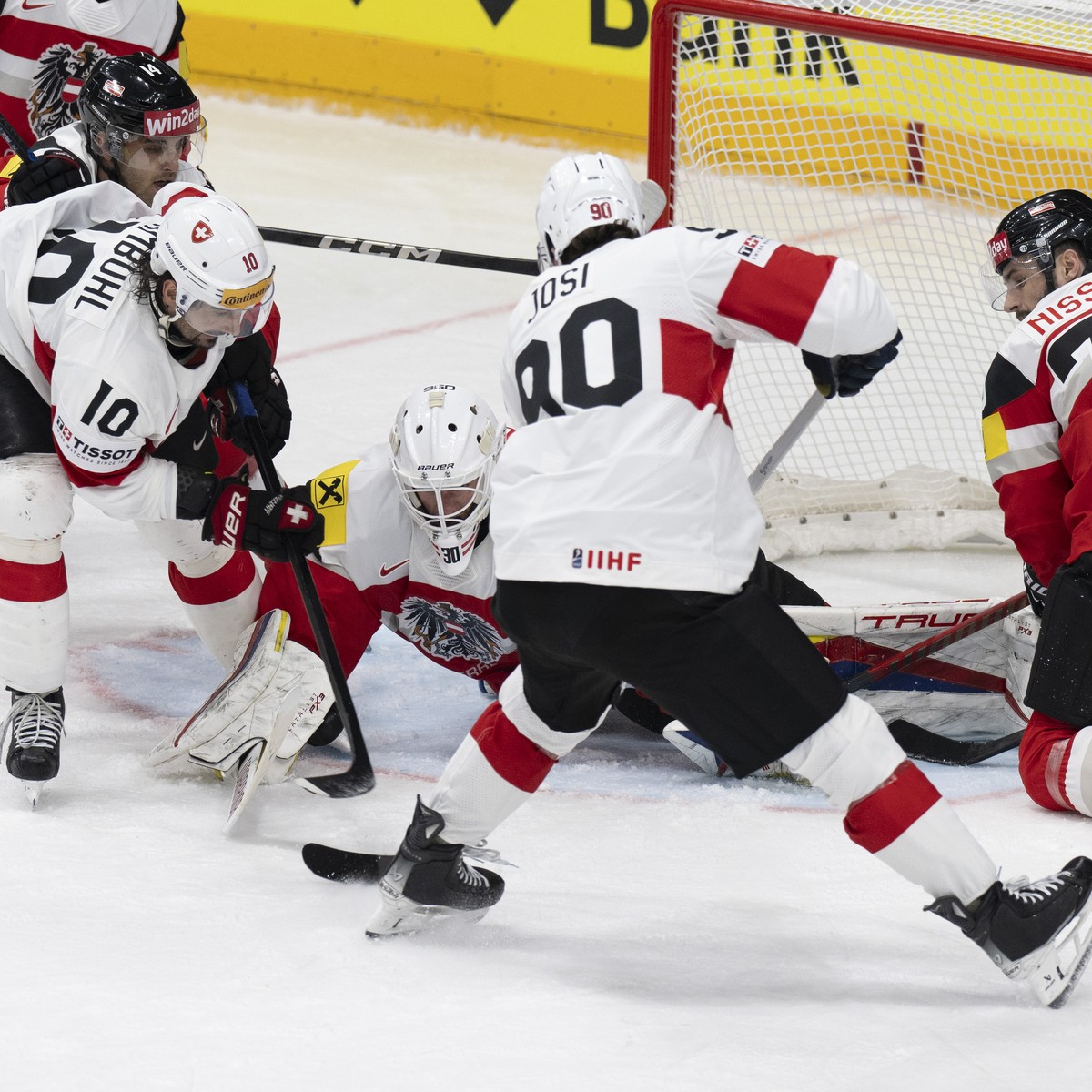 Switzerland's Roman Josi, center, scores to 3-3 against Austria's goalkeeper David Kickert, left, and Austria's Benjamin Nissner during the Ice Hockey World Championship group A prelimi ...