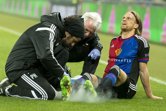 FC Basel&#039;s injured Michael Lang gets a medical treatment during the UEFA Europa League Round of 16 first leg soccer match between Switzerland&#039;s FC Basel 1893 and Spain&#039;s Sevilla Futbol  ...