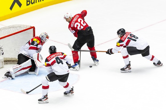 Switzerland's forward Nino Niederreiter, vies for the puck with Austria's defender Paul Stapelfeldt #18 past Austria's goaltender David Kickert and Austria's defender Ramon Schnetz ...