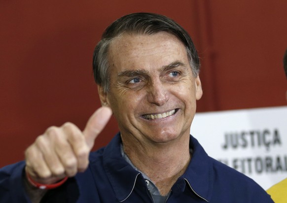 FILE - In this Oct. 7, 2018 file photo, presidential frontrunner Jair Bolsonaro, of the Social Liberal Party, flashes a thumbs up at a polling station in Rio de Janeiro, Brazil. In the first round of  ...