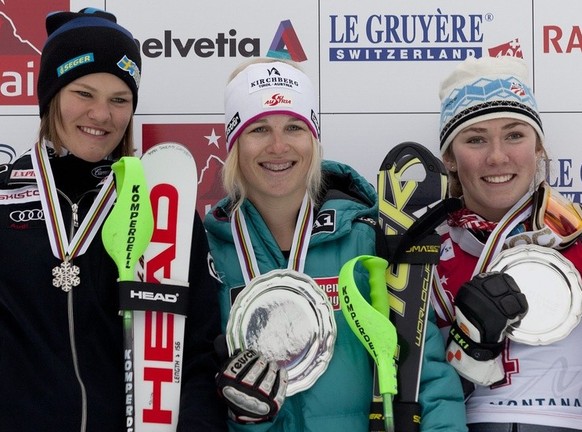 Anna Swenn-Larsson, 2nd place, left, from Sweden, Jessica Depauli, the winner, center, from Austria, Mikaela Shiffrin, 3rd place, from USA, celebrates with the medals on the podium after the women&#03 ...