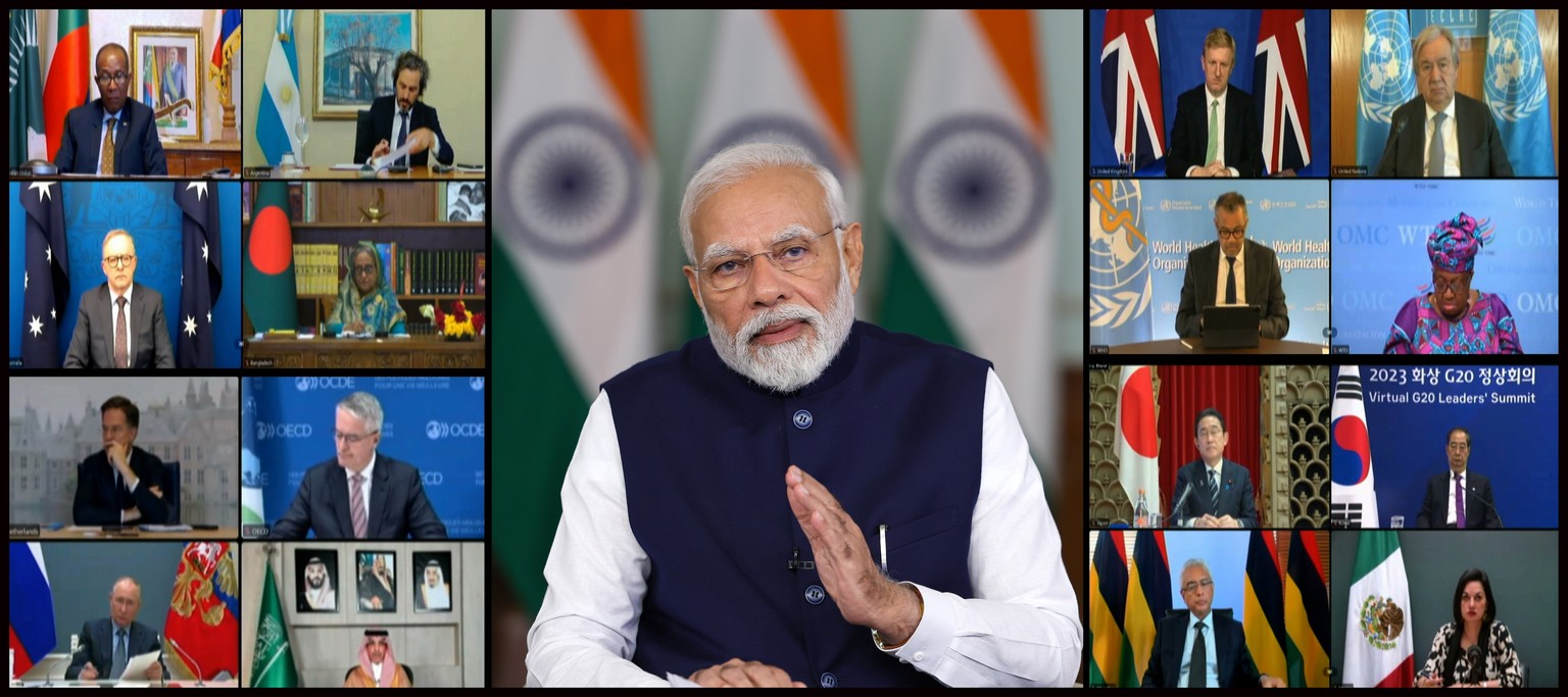 epa10989682 A handout photo made available by the Indian Press Information Bureau (PIB) shows Indian Prime Minister Narendra Modi (C) and other leaders on a screen during the G20 virtual summit in New ...