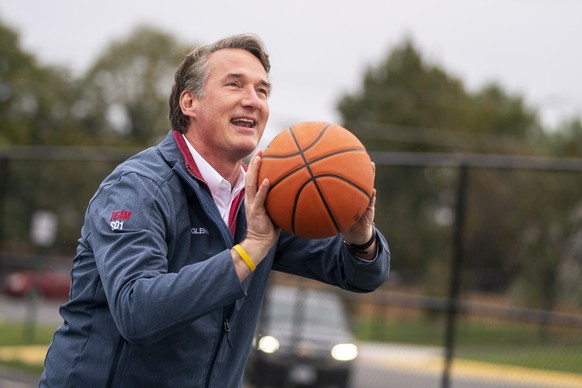 epa09559384 Virginia Republican gubernatorial candidate Glenn Youngkin plays basketball on Election Day for 2021 Virginia election at Rocky Run Middle School in Fairfax, Virginia, USA, 02 November 202 ...