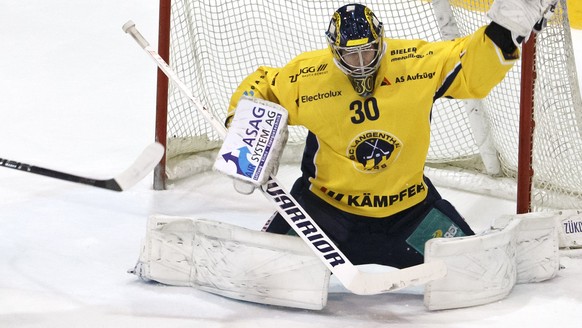 Langenthal&#039;s goaltender Philip Wuethrich, right, blocks the puck past Langenthal&#039;s defender Philippe Rytz, left, and La Chaux-de-Fonds&#039; center Alain Mieville, 2nd left, during the third ...